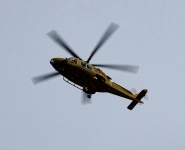 Yellow Helicopter In Flight
