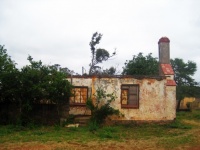 Old roofless house with chimney
