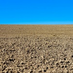 Ploughed Field And Blue Sky