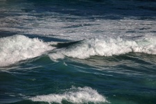 Surge of foam on a breaking wave