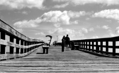 Couple walking on fishing pier
