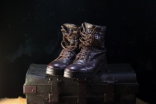 Leather combat boots on a trunk