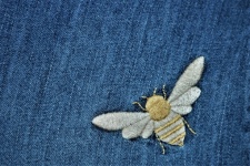 Embroidered Bee On Denim Background