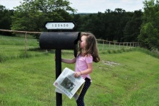 Little Girl Looking In Mailbox