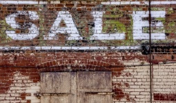 Brick Wall With SALE Painted Words
