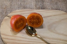Cut Tree Tomato On Wood With Spoon