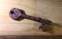 Old Rusted Key On A Wooden Surface