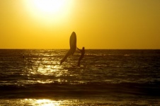 Silhouette of windsurfer at sunset