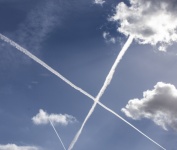 Airplane Vapors Cross In The Sky