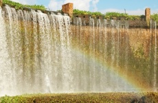 Rainbow in front of water cascade.