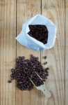 Coffee beans in a wooden scoop