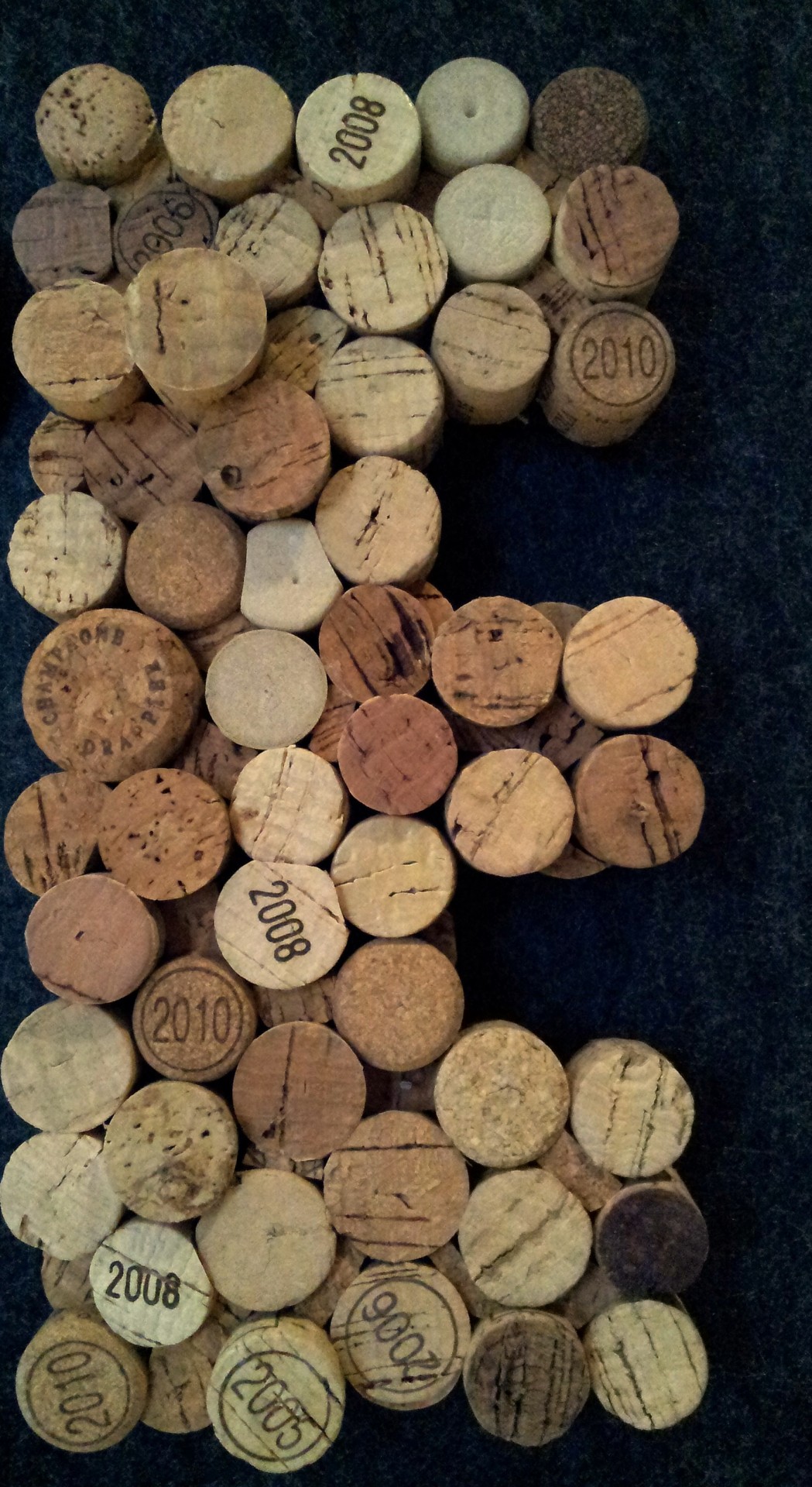 Letter E Formed By Wooden Wine Cap