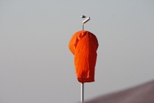 Bright orange windsock hanging limp