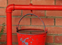 Bright red bucket filled with water